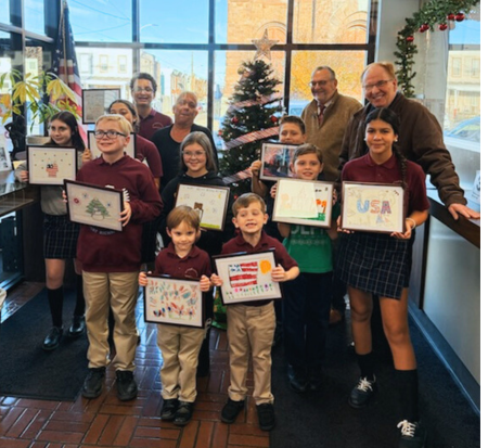 A photo of our Student artists holding their drawings