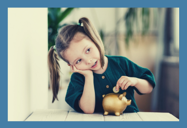 Little Girl Saving Money in a Piggy Bank